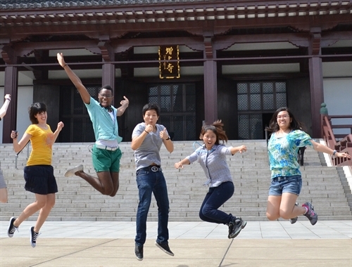 students jumping in Japan