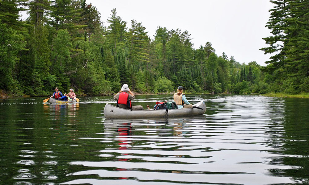 two canoes with paddlers in the boundary waters