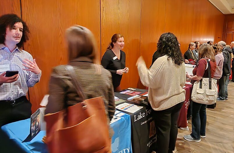 Image of college and high school counselors meeting at college fair.