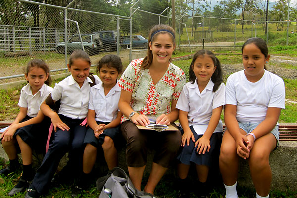 Chloe Souza with school children